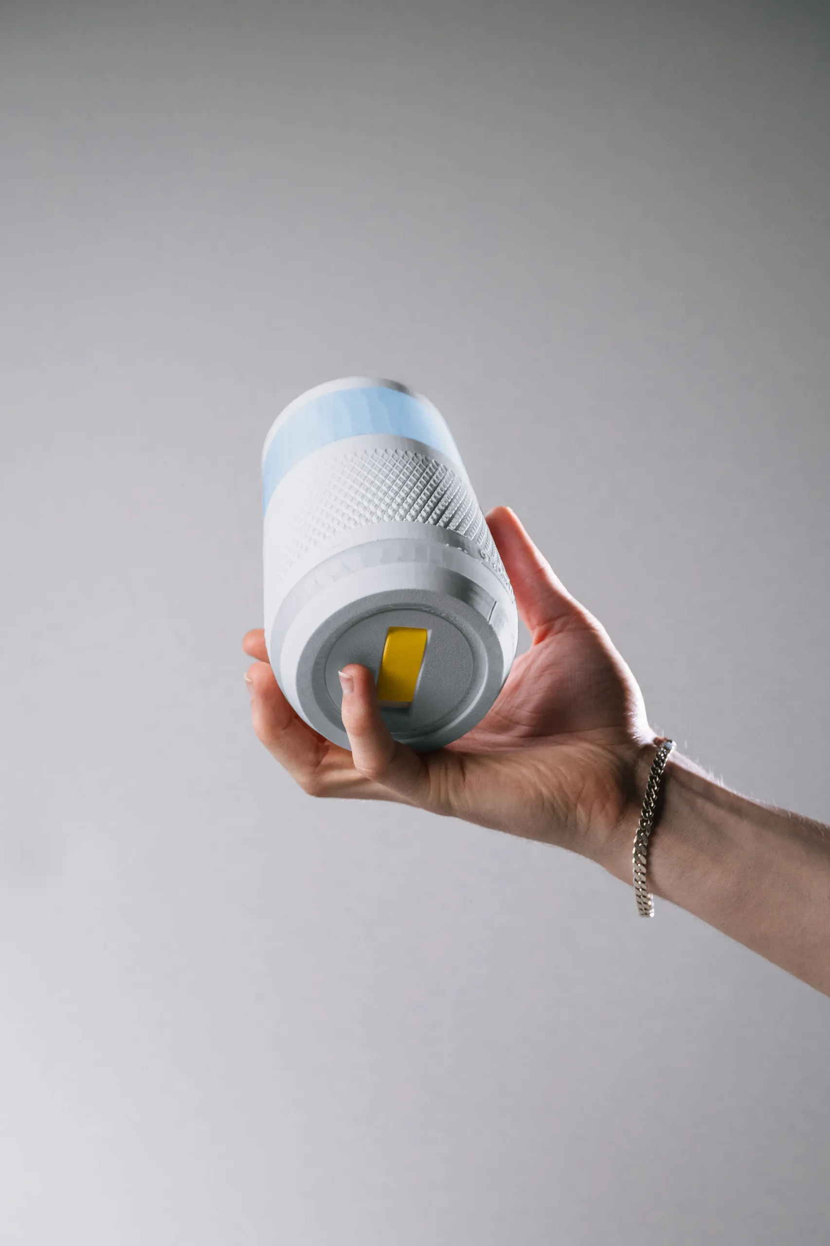 A hand holding the OrderUP device upside down