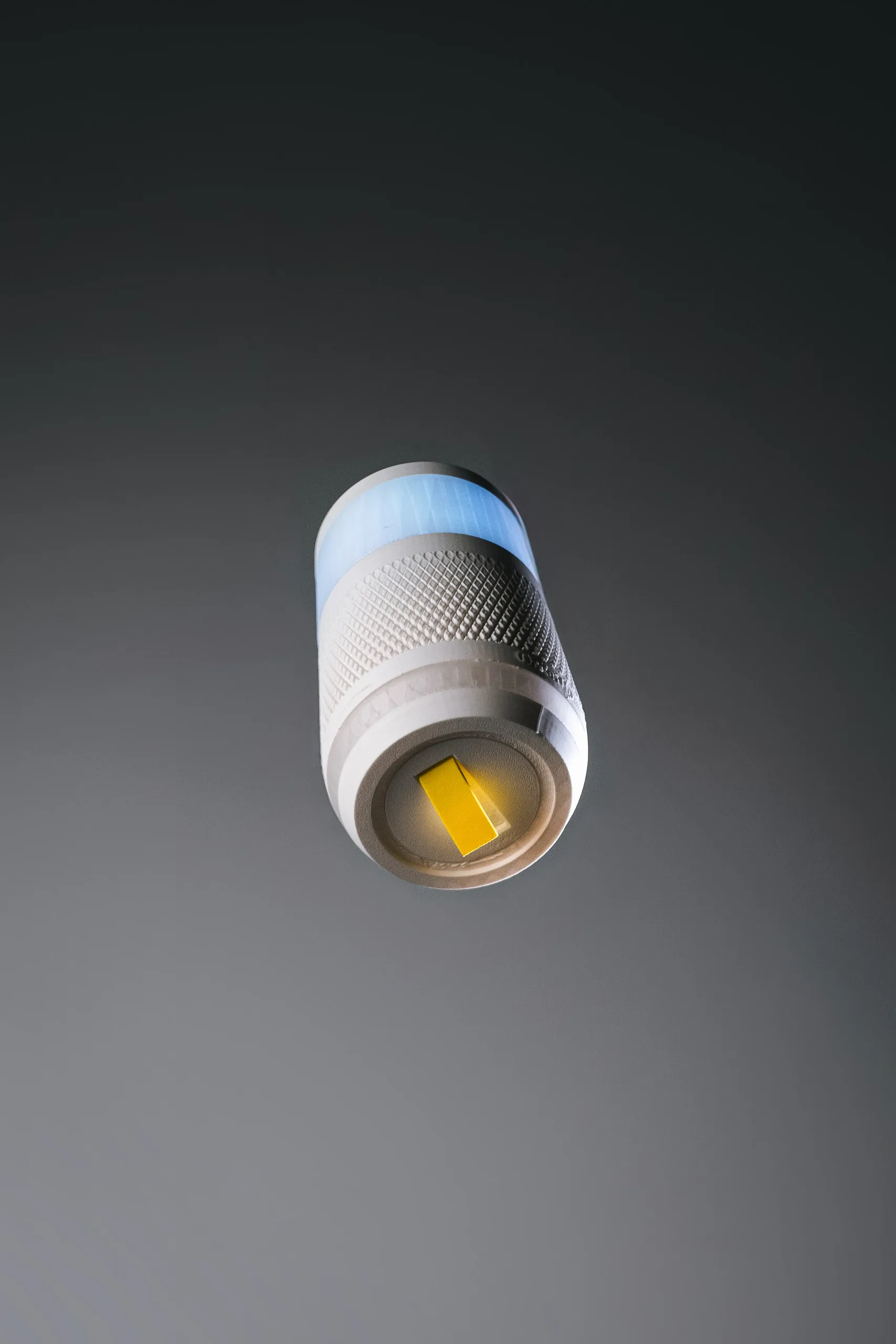 The OrderUP device floating in front of a dark grey background